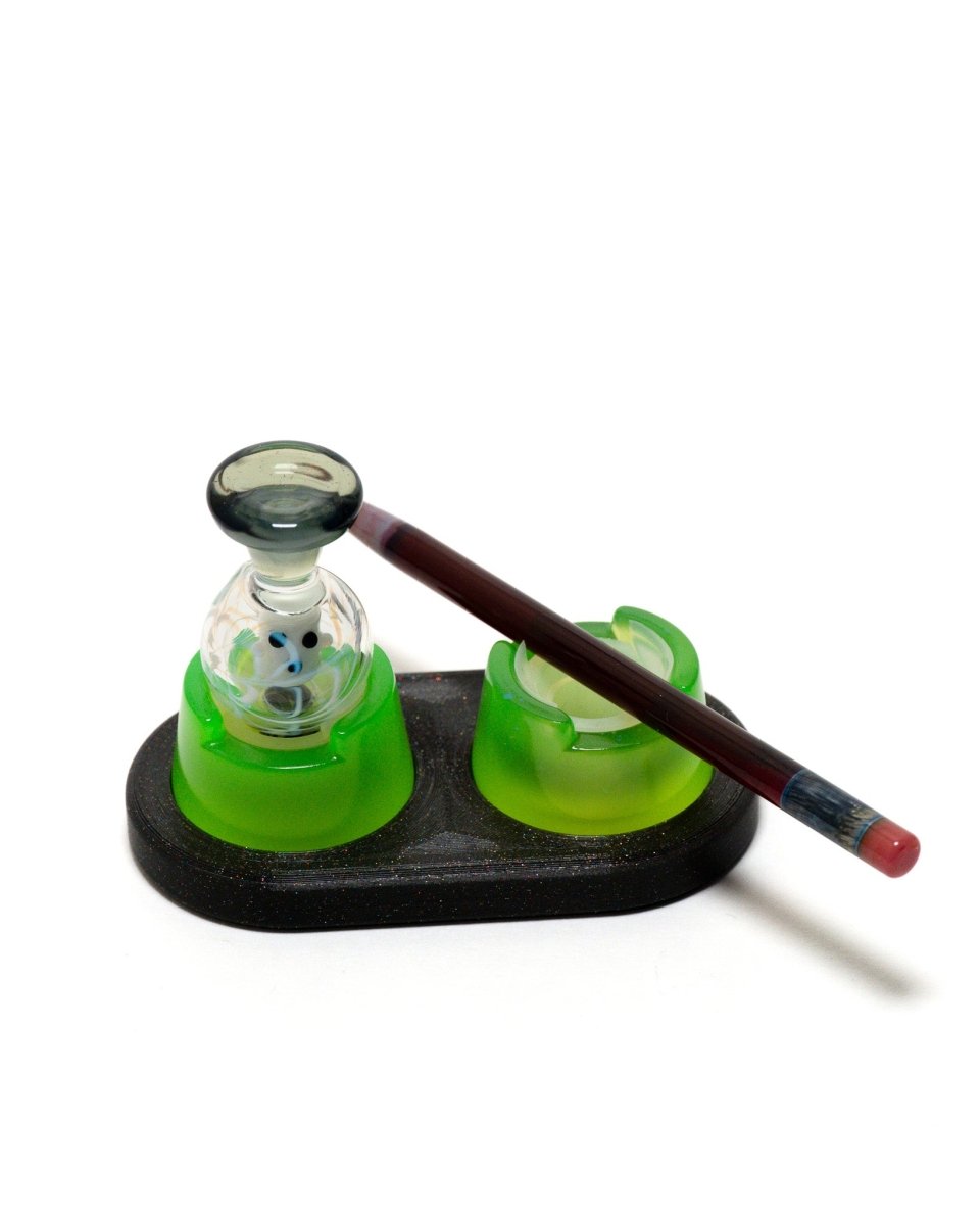 Galaxy black bubble cap doc with two resin bubble cap holders with silicone inserts. with a bubble cap and dabber in the doc.