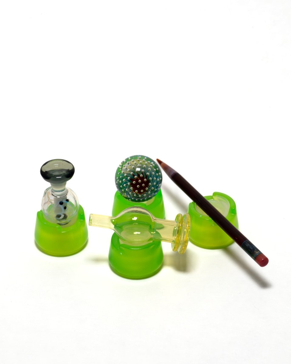 Slyme green bubble cap holders showing off how they work from holding a marble, used as a pen holder, and how it works as a secure marble holder.
